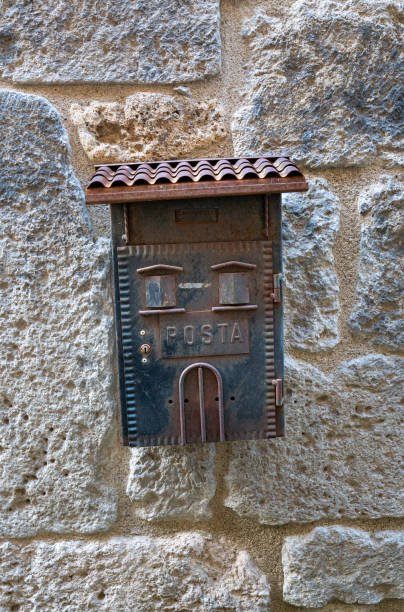 istock Vertical shot of rusty letter box on a stony wall 1448903277