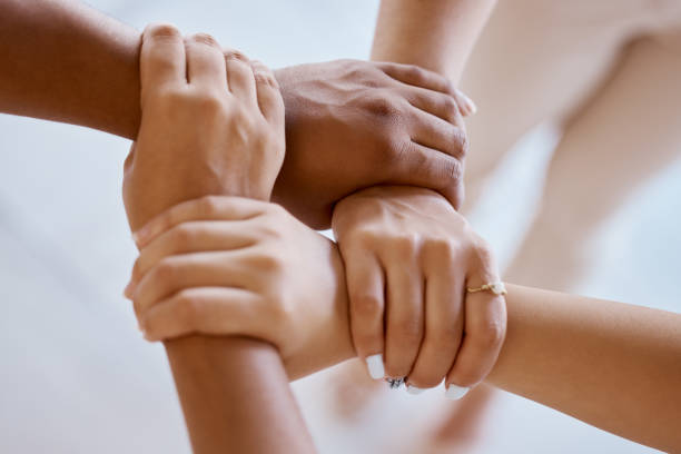 istock Hands, together and solidarity with a group of people strong in unity from above for teamwork or collaboration. Trust, support and community with a team or partnership holding a wrist for motivation 1448903582