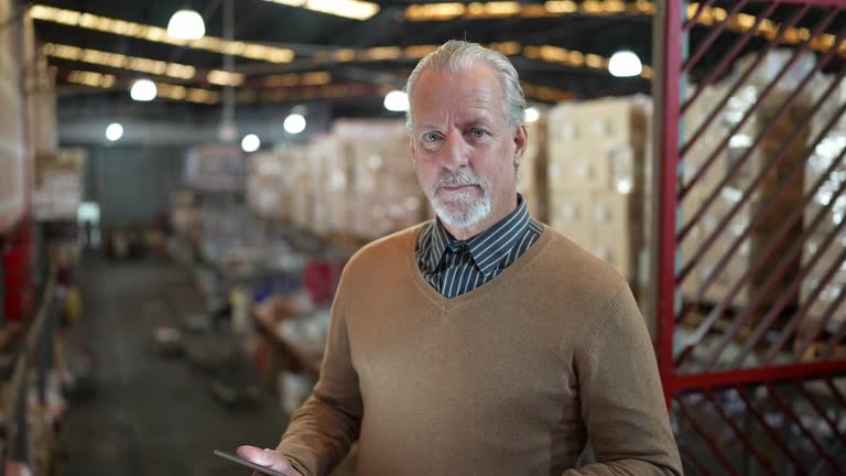 Portrait of a warehouse worker using digital tablet