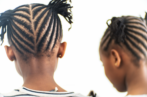 Rear view of African girl with braided hair at studio