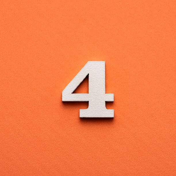 istock Number 4 - White wooden number on pink background 1448909219