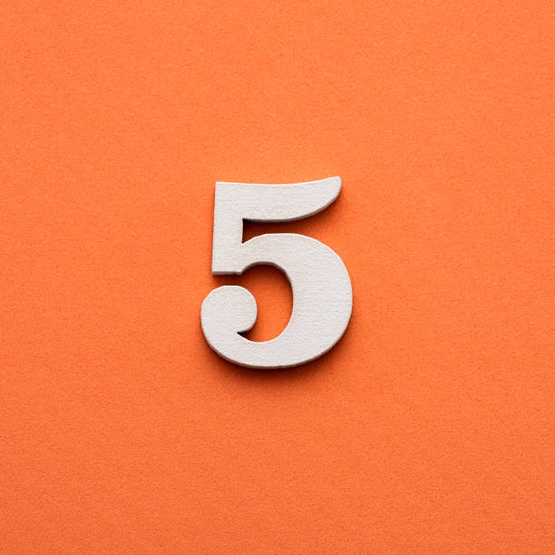 istock Number five - white number in wood on pink background 1448910406