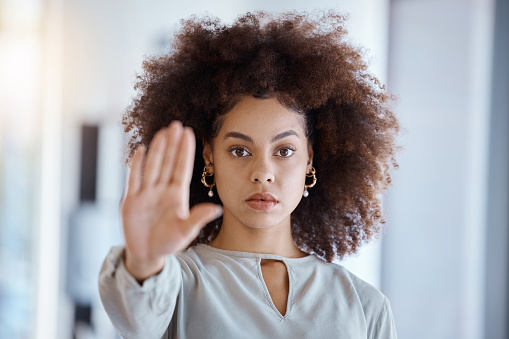 Hands, hr and manager stop sign with hand in office, serious, power and change in corporate. Black woman fighting sexual harassment, discrimination and toxic work environment with employee protection
