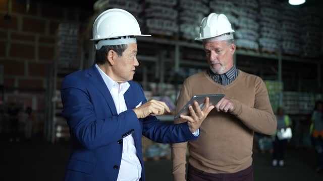 Businessmen doing a meeting in a warehouse