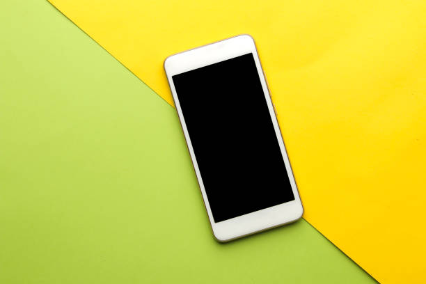 istock Smartphone. White phone on a bright multi-colored background. top view. space for text 1448912628