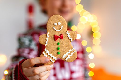 Cute kid boy holding Christmas gingerbread man