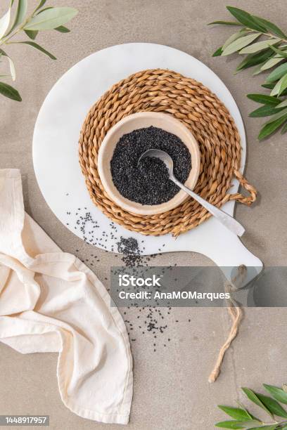 Black Sesame Seeds Or Gergelim In Ceramic Bowl With Spoon In Kitchen Countertop For Healthy Food And Diet Concepts Top View Stock Photo - Download Image Now