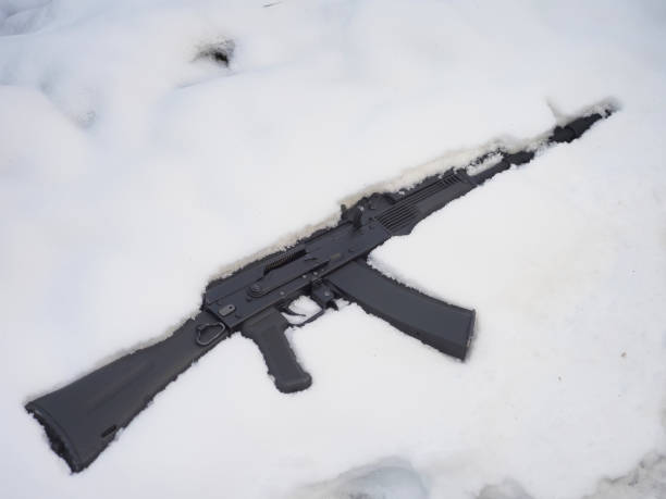 istock Black metal gun machine in snow 1448921026