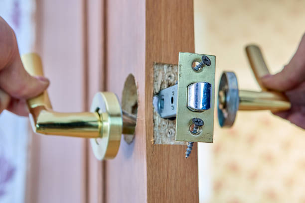 Locksmith is repairing faulty lever door handle with latch. Defective lever door handle was dismantled for repair. door lock stock pictures, royalty-free photos & images