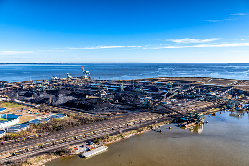 Mobile, United States - January 31, 2022:  Aerial view of the McDuffie Coal terminal, the second larges coal facility in the United States, located at the Port of Mobile, Alabama, USA along the shores of the Gulf of Mexico shot from an altitude of about 500 feet.