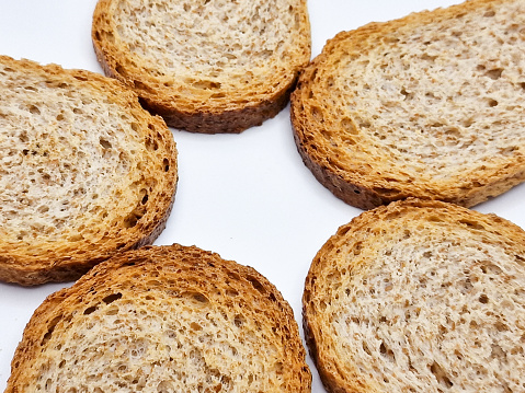 whole wheat dry rusk bread, wholemeal bread isolated on white background