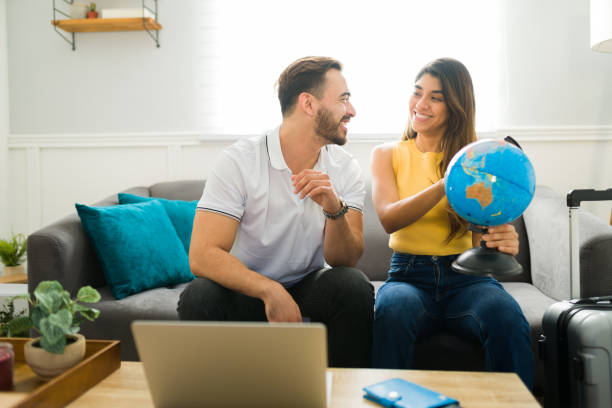 istock Smiling couple planning their vacation trip 1448932883