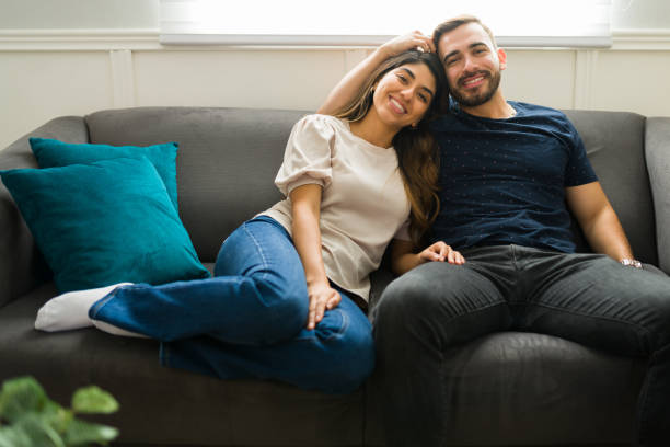 istock Beautiful couple resting together on the sofa 1448933322