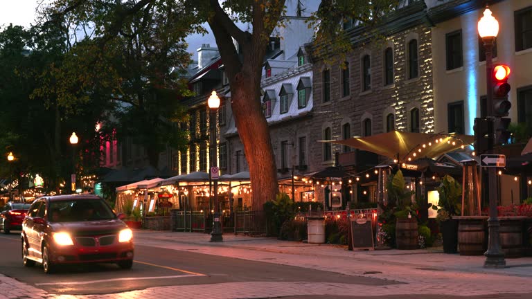 People walk along the historic restaurants and shops in downtown Quebec city Canada