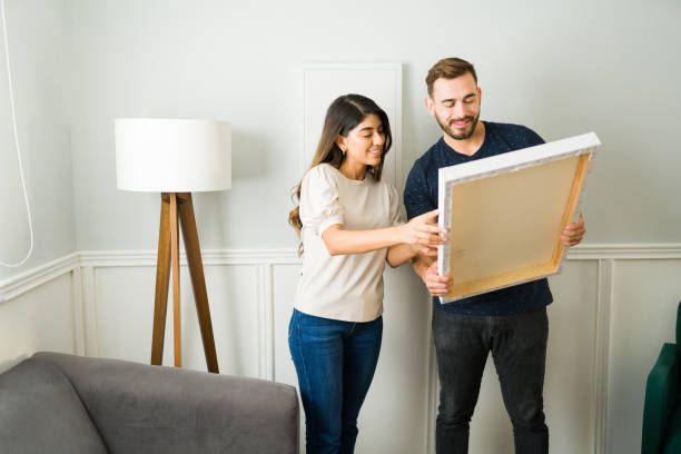 istock Happy couple moving and decorating 1448934102