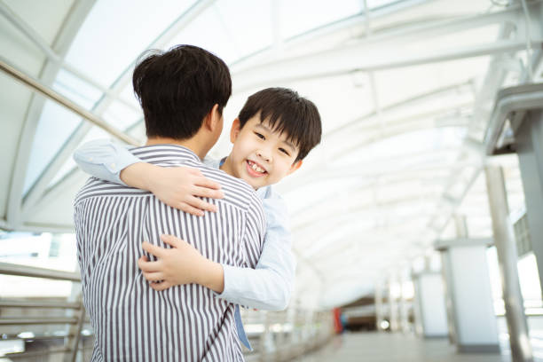 istock Boy running and hugging his father. 1448935557