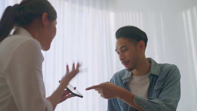 https://media.istockphoto.com/id/1448937625/video/wrost-effect-form-technology-asian-couple-having-an-argument-about-texts-in-the-smartphone-on.jpg?s=640x640&k=20&c=WVrHPvYr08JDEuDqRPpf6a5KB5aTV3DotGE6pk_Y1E4=