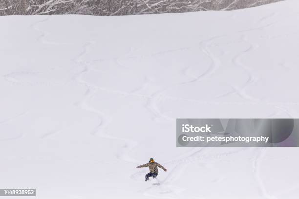Snowy Hill Background With Snowboarder Riding Down Stock Photo - Download Image Now - Iwate Prefecture, Snow, 40-44 Years