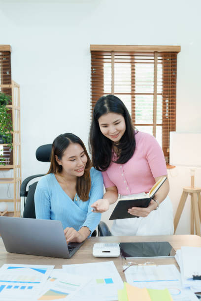 istock Financial analysts analyzing business reports on planned investment projects during corporate meeting discussions showcase successful teamwork with marketing plan, computers and calculators to work 1448941562