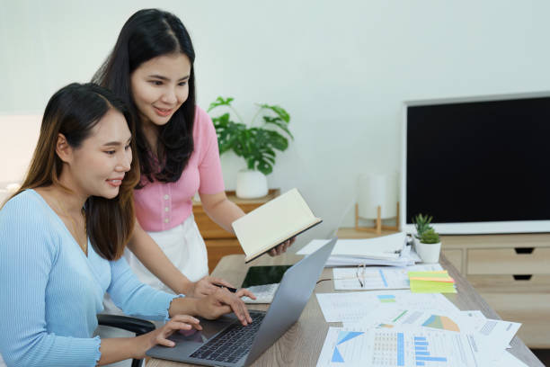 istock Financial analysts analyzing business reports on planned investment projects during corporate meeting discussions showcase successful teamwork with marketing plan, computers and calculators to work 1448942603