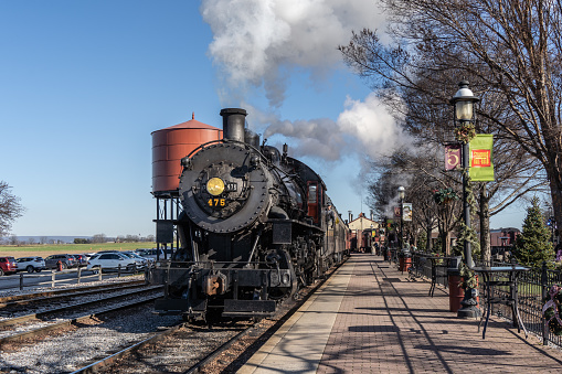 Rockhill Furnace, Pennsylvania, August 5, 2023 - An Aerial View of a Narrow Gauge Steam Passenger Train, Arriving into the Station, Blowing Smoke , on a Sunny Summer Day