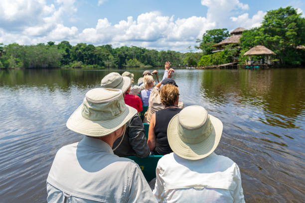 Tourist Group by Canoe, Amazon Rainforest stock photo