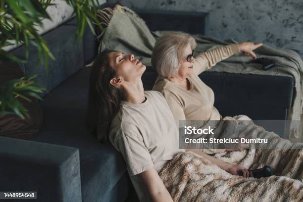 Old Woman Playing Playstation Having Fun Like Crazy Together With Her Adult Daughter Entertainment Concept With Playstation The Concept Of Having Fun Together Stock Photo - Download Image Now