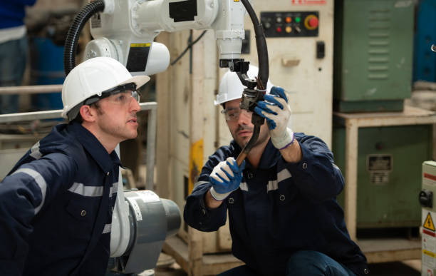 istock The two engineers check the operation of welding robots. 1448961423