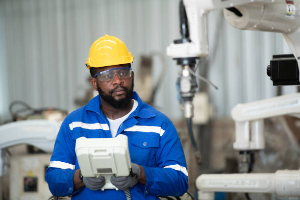 istock Young male engineers are manipulating a welding robot hand. By combining welding manipulation with a control panel for precise welding control. 1448961472