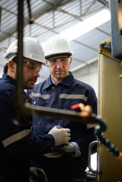 istock Both of engineers are consulting and exchanging repair experience with each other. 1448963058