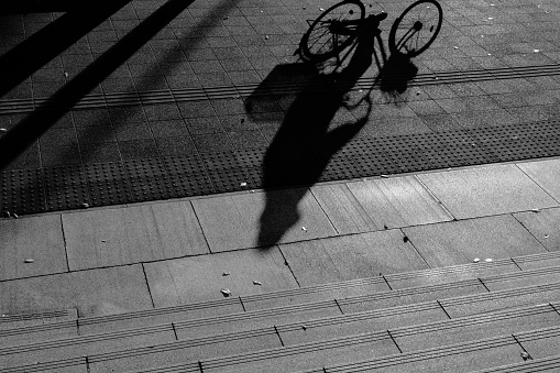 Image of a shadow of a person riding a bicycle