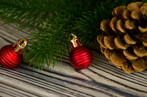 Christmas background with red Christmas tree decorations on a dark wooden board