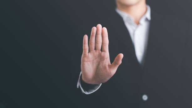 istock man hand stop sign, warning concept, refusal, caution, symbolic communication, preventing subsequent problems 1448975519