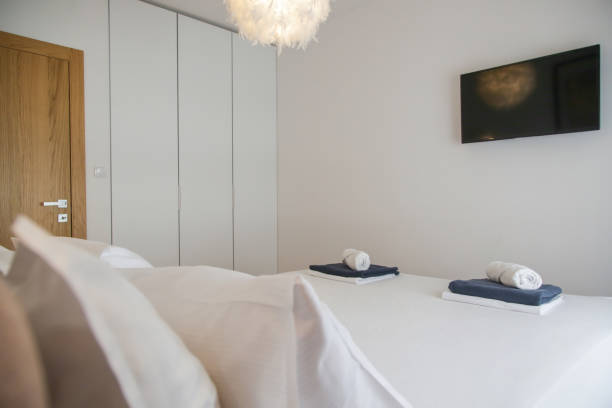 istock King size bed in simple and cozy bedroom. 1448978675