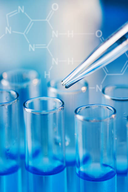 istock Test tubes with blue liquid water samples and pipette over blue background. 1448981151
