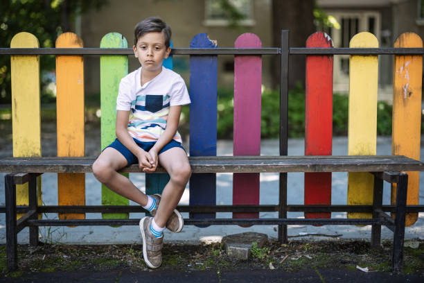 Boy sitting on a bench and feeling sad