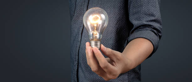 istock Humans hold light bulbs in hand innovative technology and creativity 1448982463