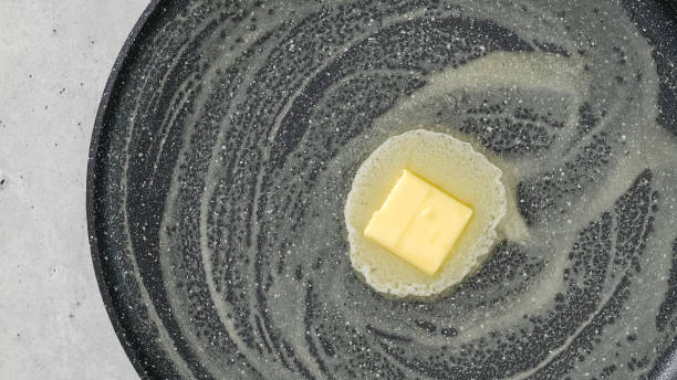 istock Piece of butter on a hot frying pan, flat lay 1448987921