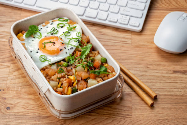Shrimp fried rice and fried egg in a lunch box Shrimp fried rice with vegetables and fried egg in a lunch box chinese cuisine fried rice asian cuisine wok stock pictures, royalty-free photos & images