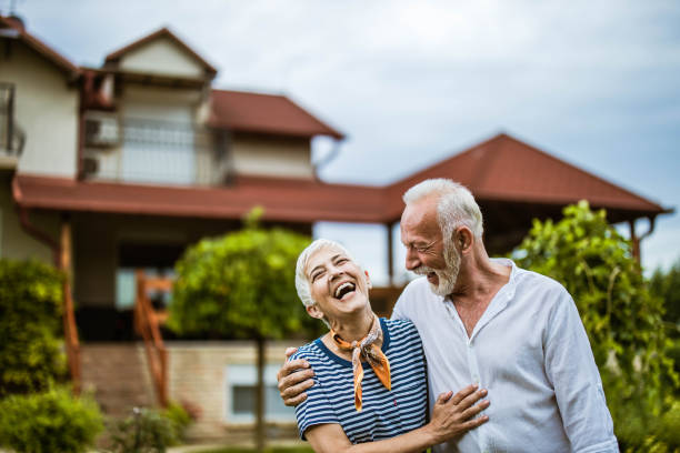 istock Embraced senior couple talking about something funny in the backyard. 1448989326
