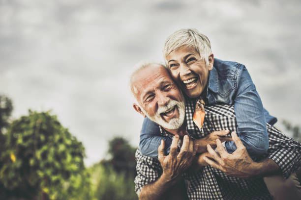 istock Playful senior couple having fun while piggybacking in nature. 1448989480