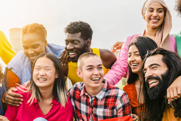 istock Diverse multi ethnic group of people having fun outdoors - non binary person, gender freedom - 1448989535