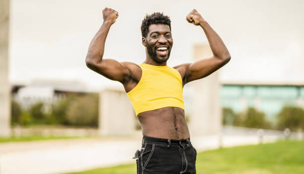 Young non-binary person, Make up an androgynous person. He shows his happy biceps with self-esteem, gender freedom.