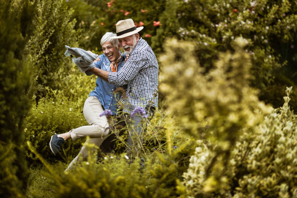 istock Cheerful senior couple having fun in the park. 1448989578