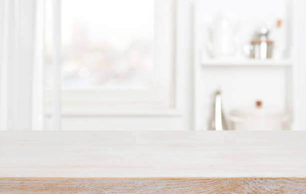 istock Empty wooden table with blurred background of home kitchen window 1448991817
