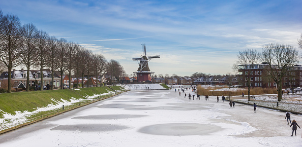 Panorama of a windmill at the frozen canals of Dokkum, Netherlands