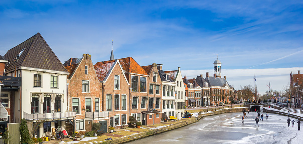 Panorama of historic houses at the frozen canals of Dokkum, Netherlands