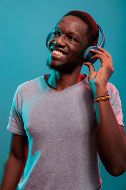 istock Happy adult enjoying record music on wireless headset 1448993049