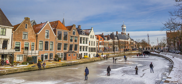 Panorama of historic houses at the frozen canals of Dokkum, netherlands