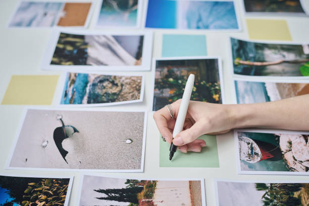 istock Photographer making collage from photos 1448995174